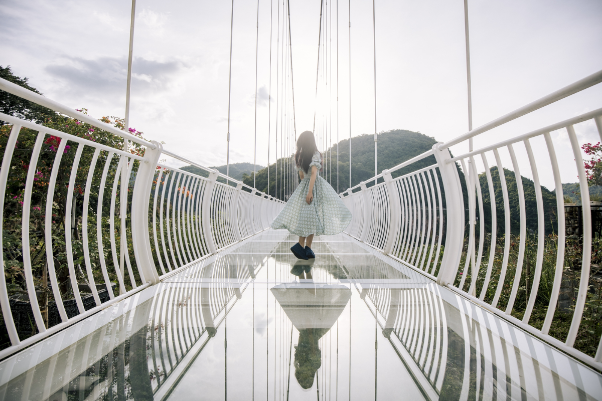 Clear glass floor on Bach Long Bridge revealing the drop below